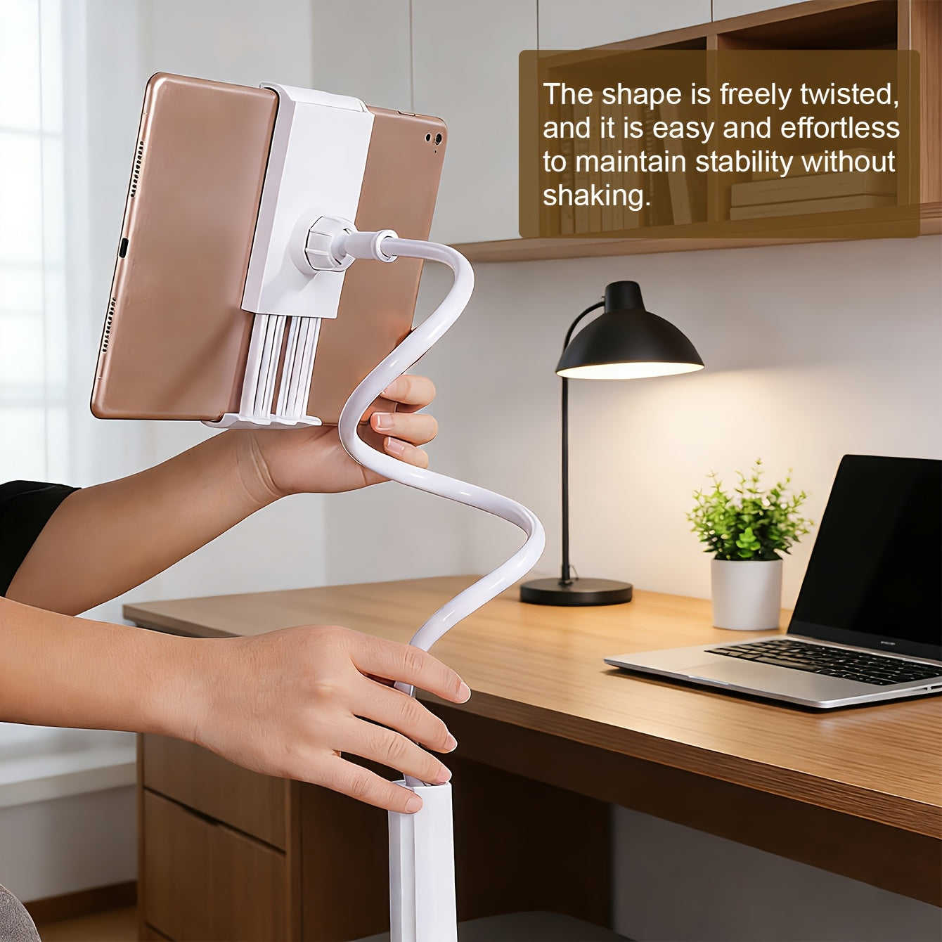 White ABS flexible gooseneck tablet holder with a rose gold tablet. Stable, adjustable clamp design on a desk.