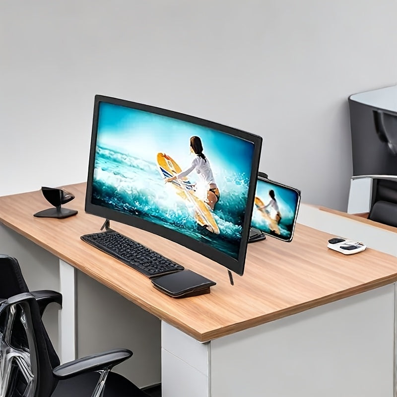 Black 12-inch curved screen magnifier displaying a surfing video, set on a light wood desk with a phone and keyboard.