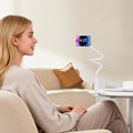 White minimalist ABS flexible gooseneck phone holder clamped to a table, used hands-free.