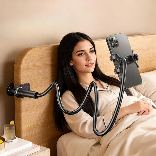 Black 360° adjustable flexible hose phone holder clamped to a wooden headboard, holding a smartphone for a woman in bed.