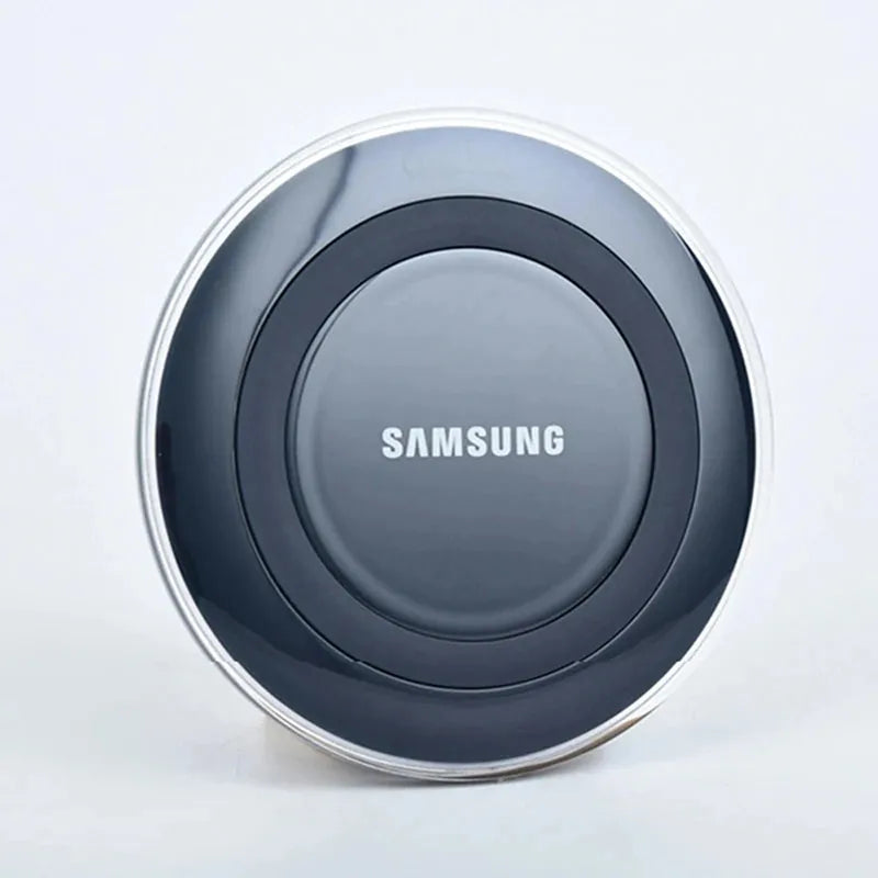Sleek, round Samsung Qi fast wireless charging pad in dark gray with a glossy finish and silver rim.