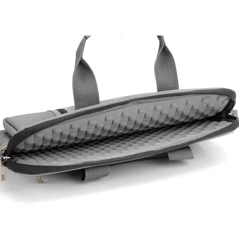 Grey polyester laptop sleeve open, revealing a padded, shock-resistant interior. Features a zipper closure and top carry handles.