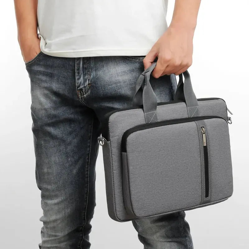 Unisex grey polyester laptop bag with handle, front zip pocket, and sleek design, fitting 13-17 inch laptops.
