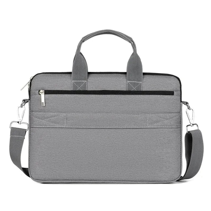 Unisex grey polyester laptop messenger bag with top handles, detachable shoulder strap, and front zipper pocket.