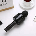 Portable black wireless karaoke microphone and Bluetooth speaker with multi-function controls.