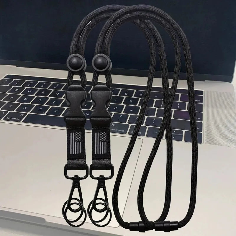 Two black heavy-duty polyester lanyards with quick-release buckles, safety breakaways, flag detail, and metal clips.