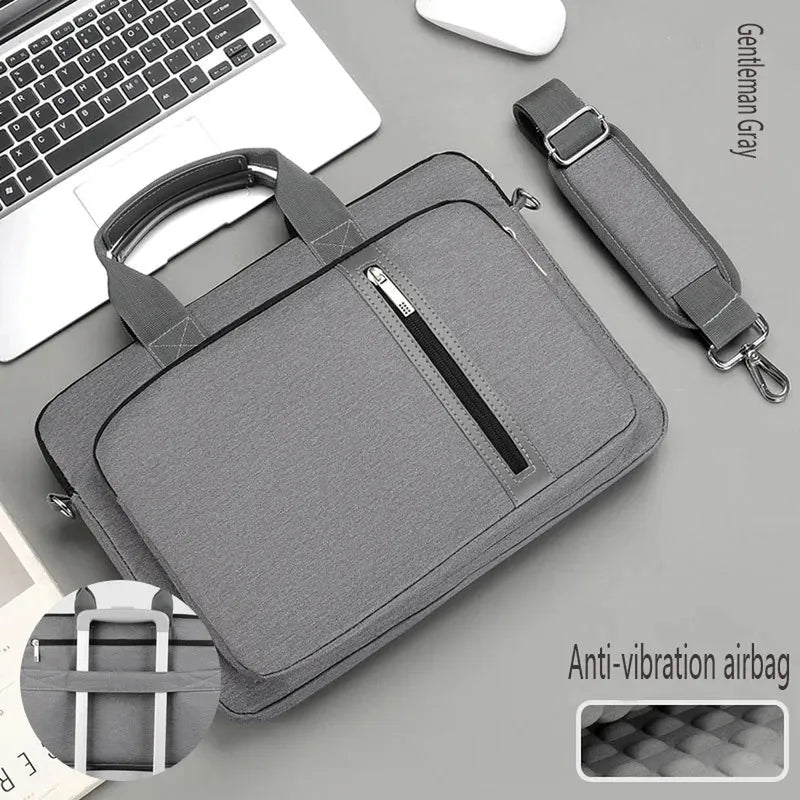 Gentleman Gray polyester laptop bag with front zip, top handles, detachable strap, luggage strap, and anti-vibration interior.