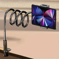 Sleek dark metallic flexible gooseneck tablet and phone stand with a coiled arm and sturdy clamp base, holding a tablet.